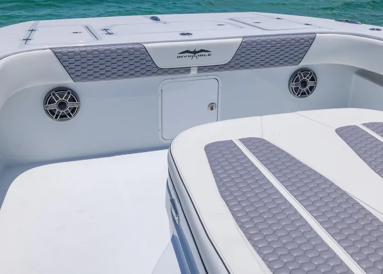  Yacht Photos Pics 2026 Invincible 38 Catamaran interior with gray seating and speakers, on turquoise water.