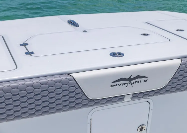  Yacht Photos Pics 2026 Invincible 38 Catamaran deck with logo, featuring sleek design and ocean backdrop.