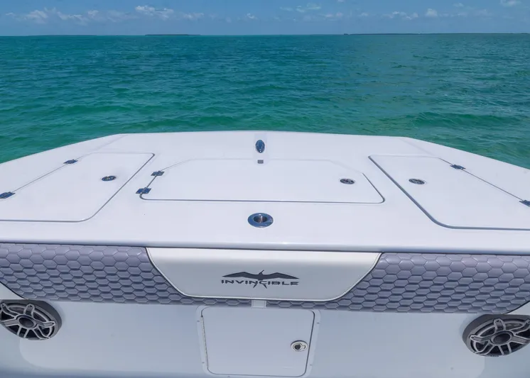  Yacht Photos Pics 2026 Invincible 38 Catamaran on turquoise ocean waters under clear blue sky.