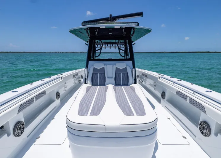  Yacht Photos Pics 2026 Invincible 38 Catamaran on turquoise water, showcasing sleek design and spacious deck.