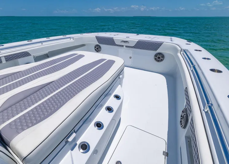  Yacht Photos Pics 2026 Invincible 38 Catamaran with spacious deck and seating, cruising on clear blue waters.