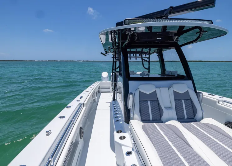  Yacht Photos Pics 2026 Invincible 38 Catamaran on open water, showcasing sleek design and luxury seating.