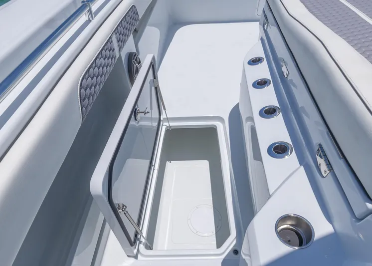  Yacht Photos Pics 2026 Invincible 38 Catamaran interior with open storage compartment and cup holders.