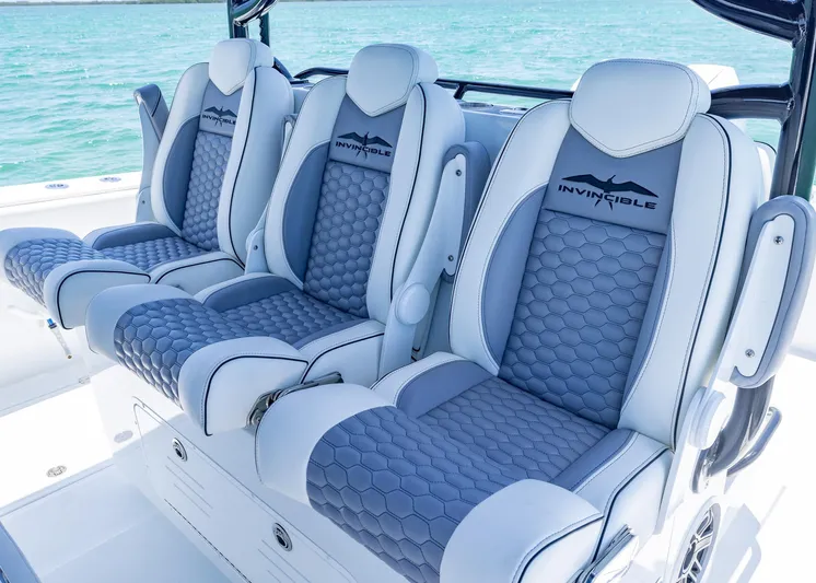  Yacht Photos Pics Luxury seating on 2026 Invincible 38 Catamaran, featuring stylish blue and white upholstery.
