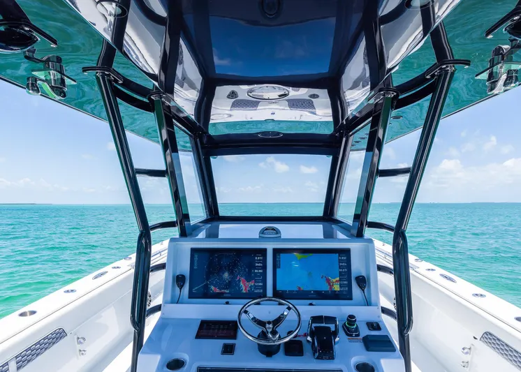  Yacht Photos Pics 2026 Invincible 38 Catamaran dashboard with dual screens, steering wheel, and ocean view.