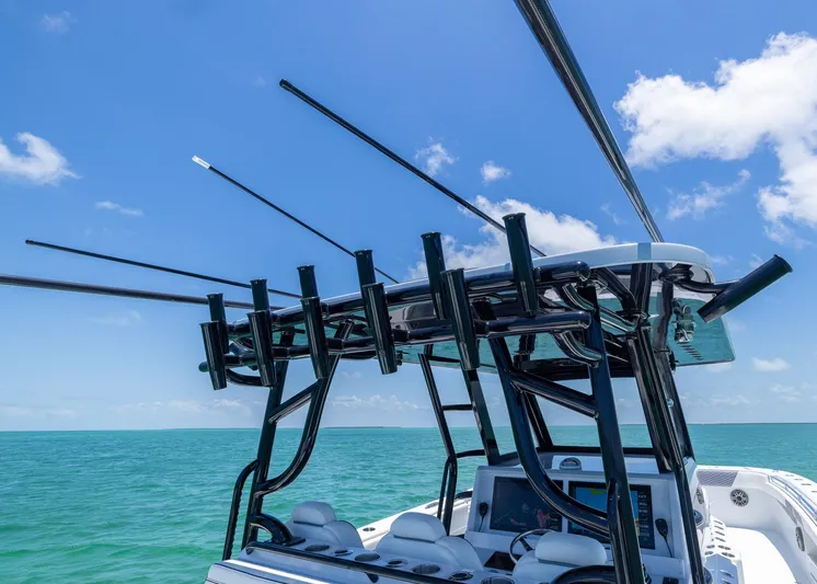  Yacht Photos Pics 2026 Invincible 38 Catamaran with fishing rod holders, ocean view, and clear blue sky.