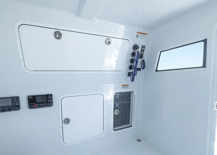  Yacht Photos Pics 2026 Invincible 38 Catamaran interior with control panels and storage compartments.