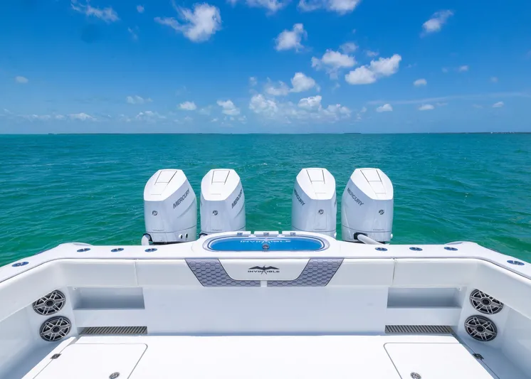  Yacht Photos Pics 2026 Invincible 38 Catamaran with four engines, cruising on clear blue ocean waters.