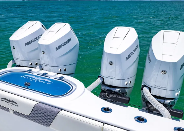  Yacht Photos Pics 2026 Invincible 38 Catamaran with four Mercury outboard engines on turquoise water.