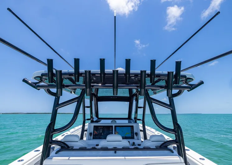  Yacht Photos Pics 2026 Invincible 38 Catamaran on turquoise water, featuring advanced navigation equipment and rod holders.