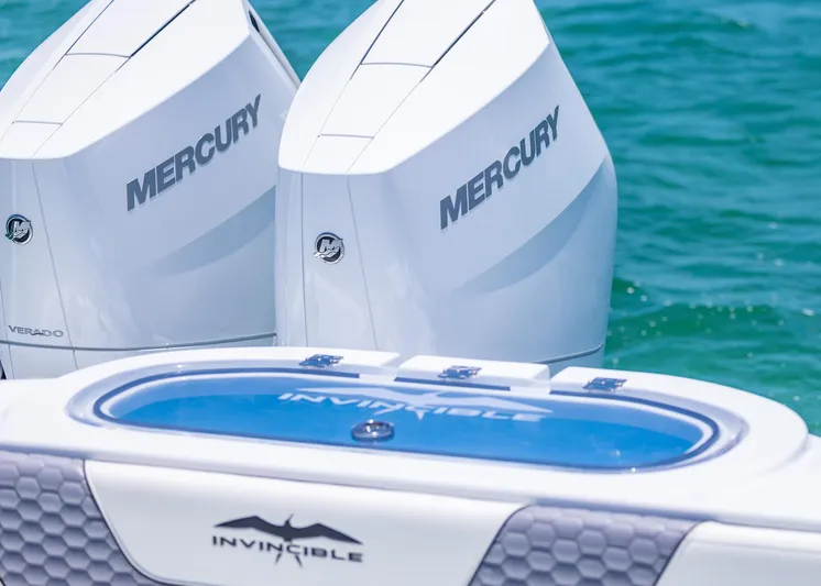  Yacht Photos Pics 2026 Invincible 38 Catamaran with twin Mercury outboard engines on blue water.