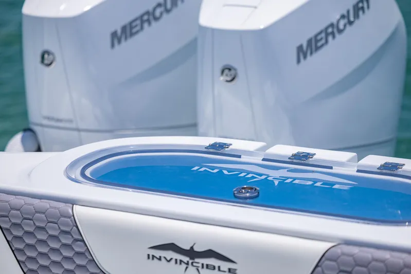  Yacht Photos Pics 2026 Invincible 38 Catamaran with Mercury engines, featuring sleek design and branding.