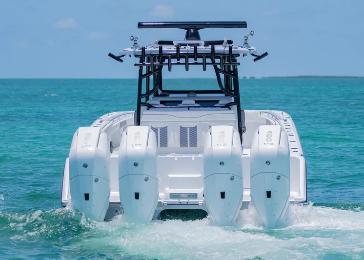  Yacht Photos Pics 2026 Invincible 38 Catamaran with four engines cruising on clear blue water.