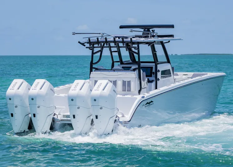  Yacht Photos Pics 2026 Invincible 38 Catamaran cruising on clear blue water with four powerful engines.