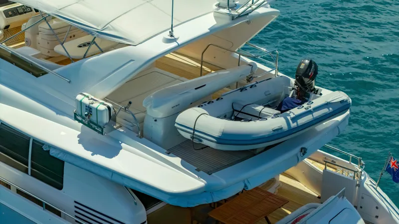 Blue Rose Yacht Photos Pics Luxury Princess 23M yacht from 2006 with inflatable boat on deck, cruising in blue waters.