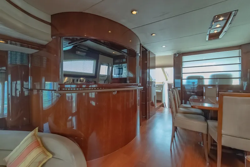 Blue Rose Yacht Photos Pics Luxurious interior of 2006 Princess 23M yacht with elegant wood finishes and modern seating.