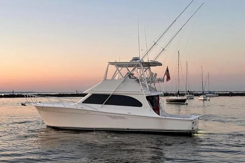  Yacht Photos Pics 2007 Egg Harbor 43 SportYacht on calm water at sunset, with sailboats in the background.