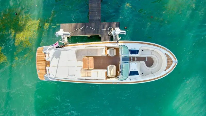 Minsky's Folly II Yacht Photos Pics Aerial view of 2014 Chris-Craft Launch 32 docked on turquoise water.