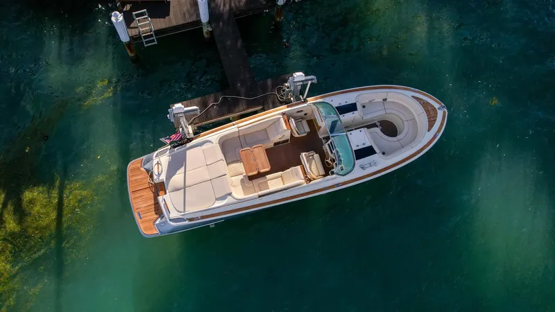 Minsky's Folly II Yacht Photos Pics 2014 Chris-Craft Launch 32 boat docked in clear water, aerial view.