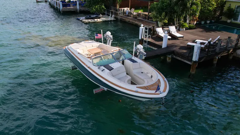 Minsky's Folly II Yacht Photos Pics 2014 Chris-Craft Launch 32 boat docked on clear blue water.