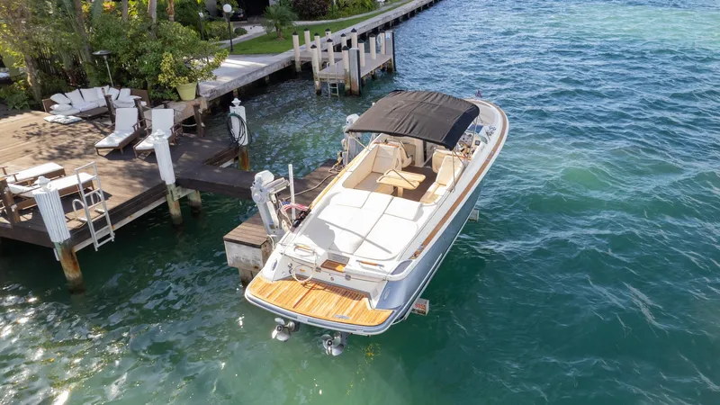 Minsky's Folly II Yacht Photos Pics 2014 Chris-Craft Launch 32 boat docked on clear blue water.