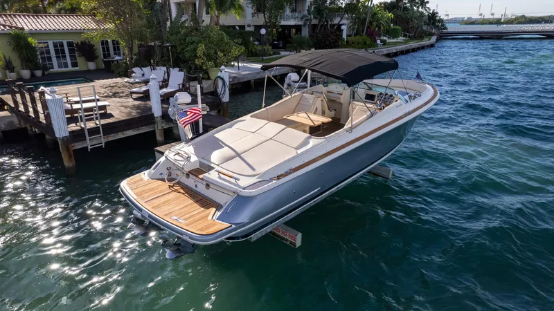 Minsky's Folly II Yacht Photos Pics 2014 Chris-Craft Launch 32 boat docked on clear blue water.