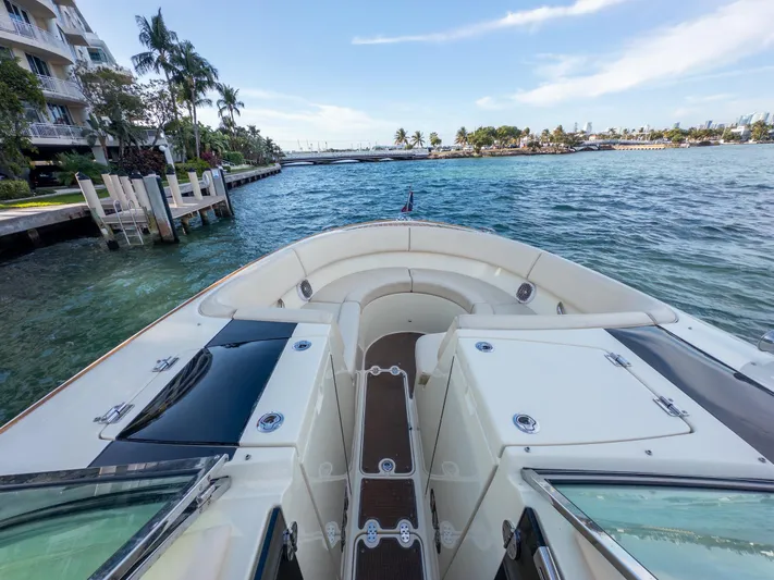 Minsky's Folly II Yacht Photos Pics 2014 Chris-Craft Launch 32 boat on scenic waterfront with palm trees.