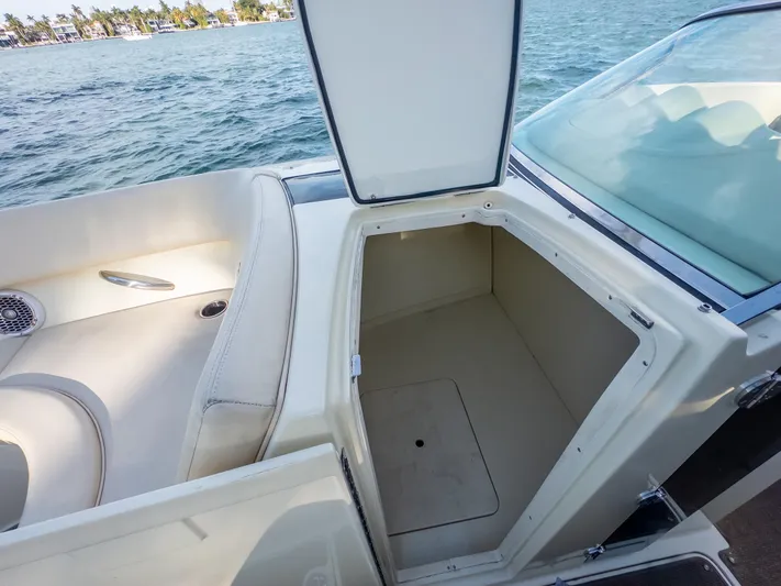 Minsky's Folly II Yacht Photos Pics 2014 Chris-Craft Launch 32 boat with open storage compartment, near water.
