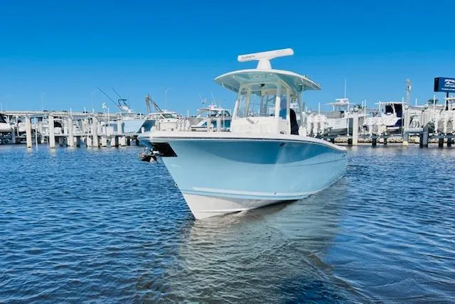  Yacht Photos Pics 2021 Cobia 301 Center Console boat docked in marina under clear blue sky.