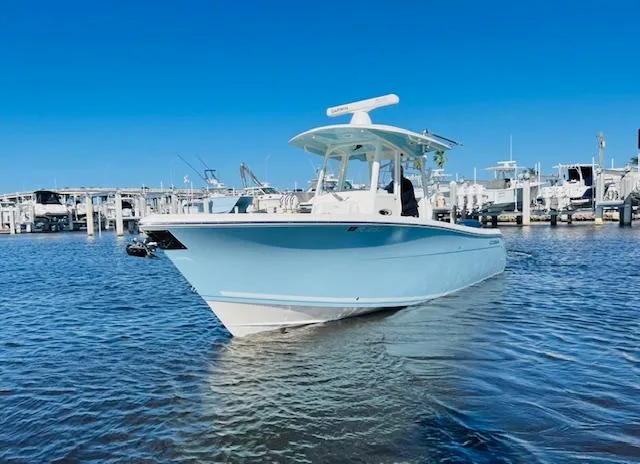  Yacht Photos Pics 2021 Cobia 301 Center Console boat docked in marina under clear blue sky.
