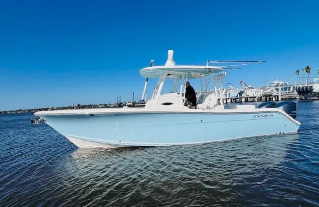 Yacht Photos Pics 2021 Cobia 301 Center Console boat on calm water under clear blue sky.
