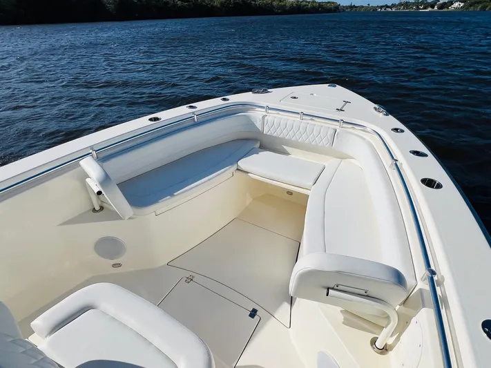  Yacht Photos Pics 2021 Cobia 301 Center Console boat interior with white seating on calm water.
