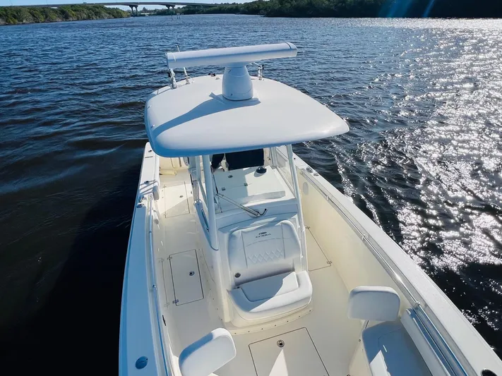  Yacht Photos Pics 2021 Cobia 301 Center Console boat on a sunny day, cruising on open water.