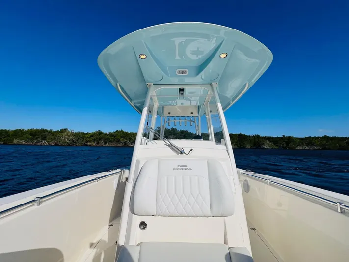  Yacht Photos Pics 2021 Cobia 301 Center Console boat on open water under clear blue sky.
