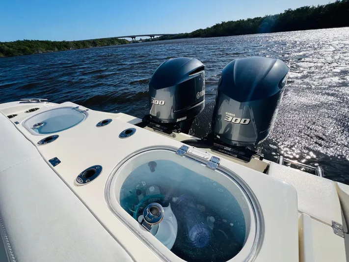  Yacht Photos Pics 2021 Cobia 301 Center Console boat with twin 300 engines on a sunny day.