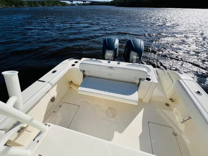  Yacht Photos Pics 2021 Cobia 301 Center Console boat with dual engines on a sunny day.