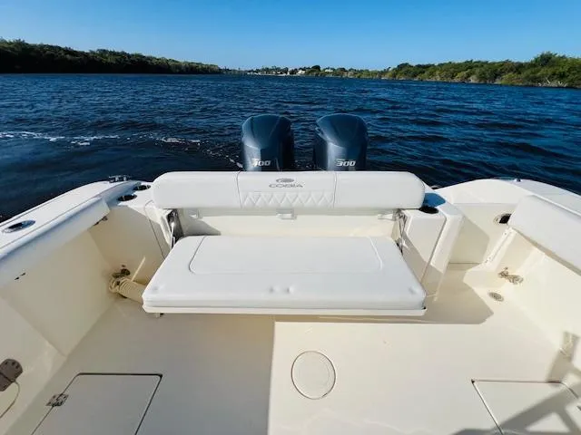  Yacht Photos Pics 2021 Cobia 301 Center Console boat with dual engines on a calm waterway.