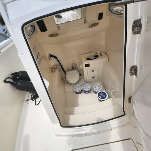  Yacht Photos Pics 2021 Cobia 301 Center Console interior with storage and marine toilet.