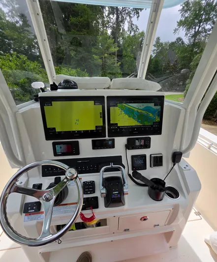  Yacht Photos Pics 2021 Cobia 301 Center Console boat dashboard with dual navigation screens and steering wheel.