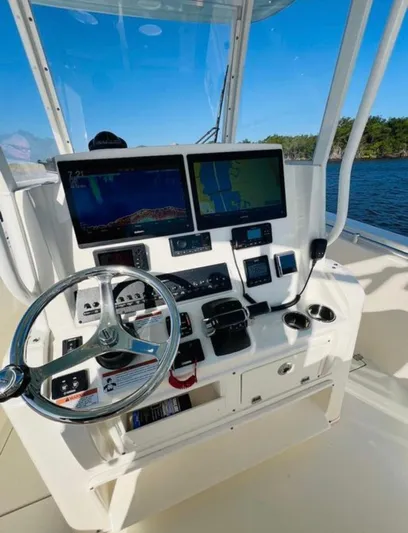 Yacht Photos Pics 2021 Cobia 301 Center Console boat dashboard with dual screens and steering wheel.