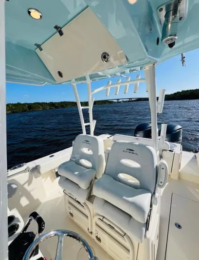  Yacht Photos Pics 2021 Cobia 301 Center Console boat interior with seating, on a sunny day at sea.