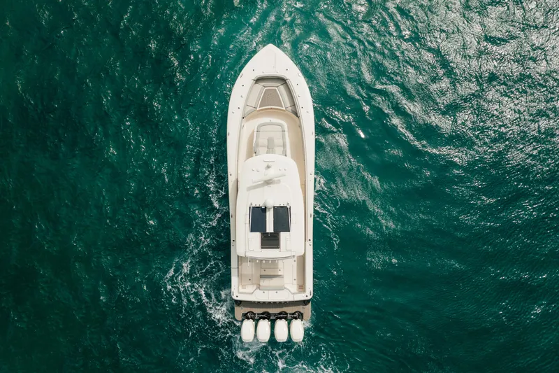 Mmxxi Yacht Photos Pics Aerial view of 2021 Scout 380 LXF boat cruising on turquoise water.