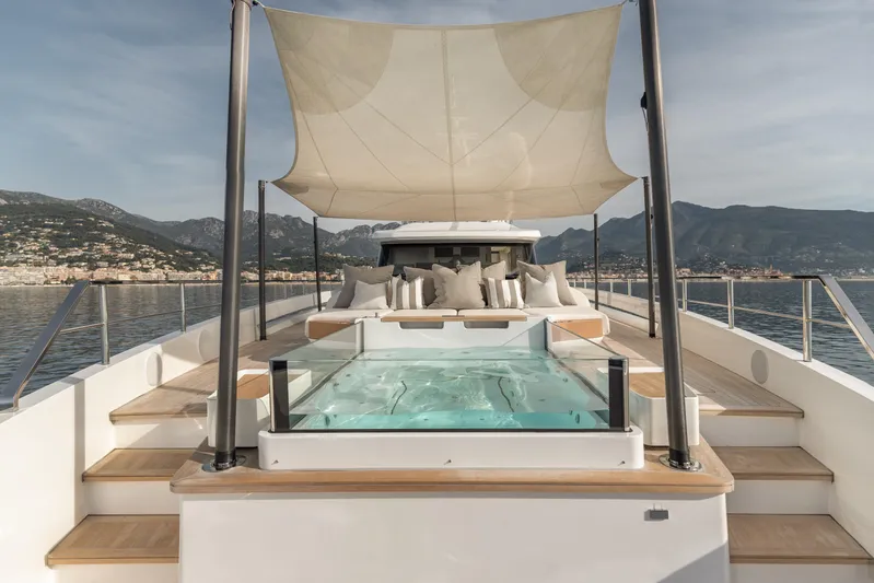 H Yacht Photos Pics Luxurious 2023 Azimut Grande 35m yacht with sun deck and jacuzzi, scenic coastal view.