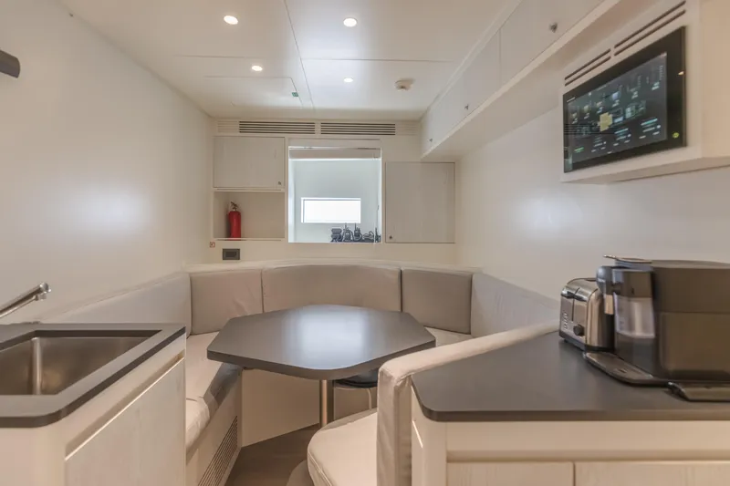 H Yacht Photos Pics Modern interior of 2023 Azimut Grande 35m yacht with kitchenette and seating area.
