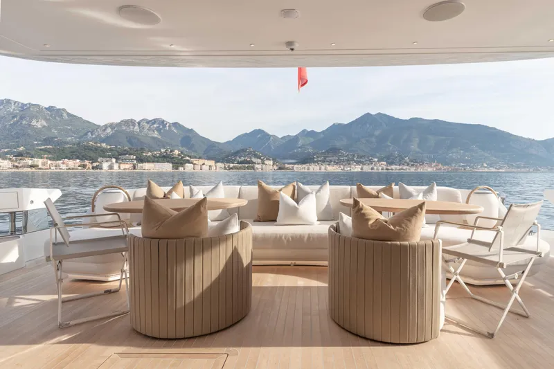 H Yacht Photos Pics Luxurious Azimut Grande 35m yacht deck with elegant seating, overlooking serene coastal mountains.