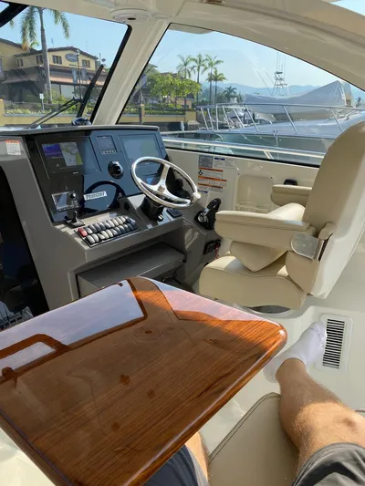 Recovery Room Yacht Photos Pics 2020 Pursuit OS 325 Offshore boat interior with helm, controls, and seating.