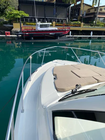 Recovery Room Yacht Photos Pics 2020 Pursuit OS 325 Offshore boat docked in a serene marina setting.