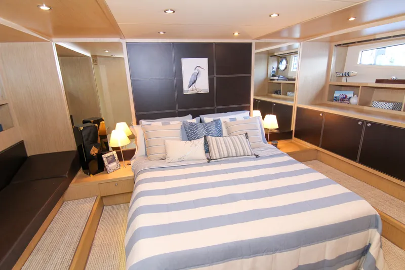 Love Life Yacht Photos Pics Luxurious bedroom interior of 2009 Riva 68' EGO SUPER yacht with striped bedding.