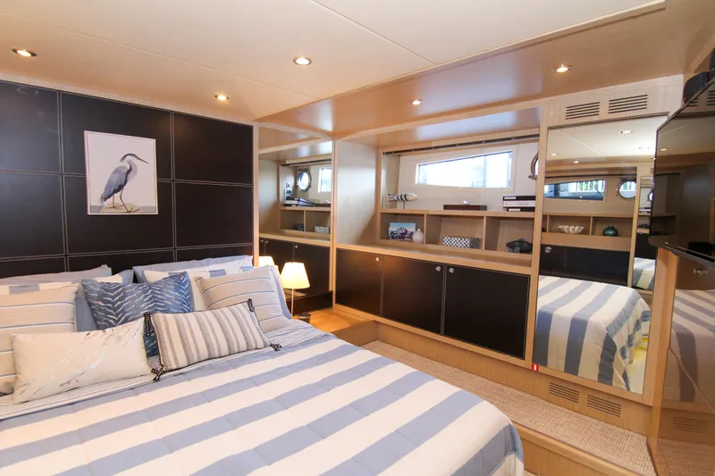 Love Life Yacht Photos Pics Luxurious bedroom interior of 2009 Riva 68' EGO SUPER yacht with striped bedding.