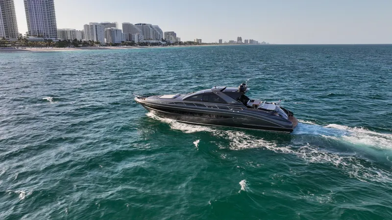 Love Life Yacht Photos Pics Luxurious 2009 Riva 68' EGO SUPER yacht cruising near a coastal city skyline.